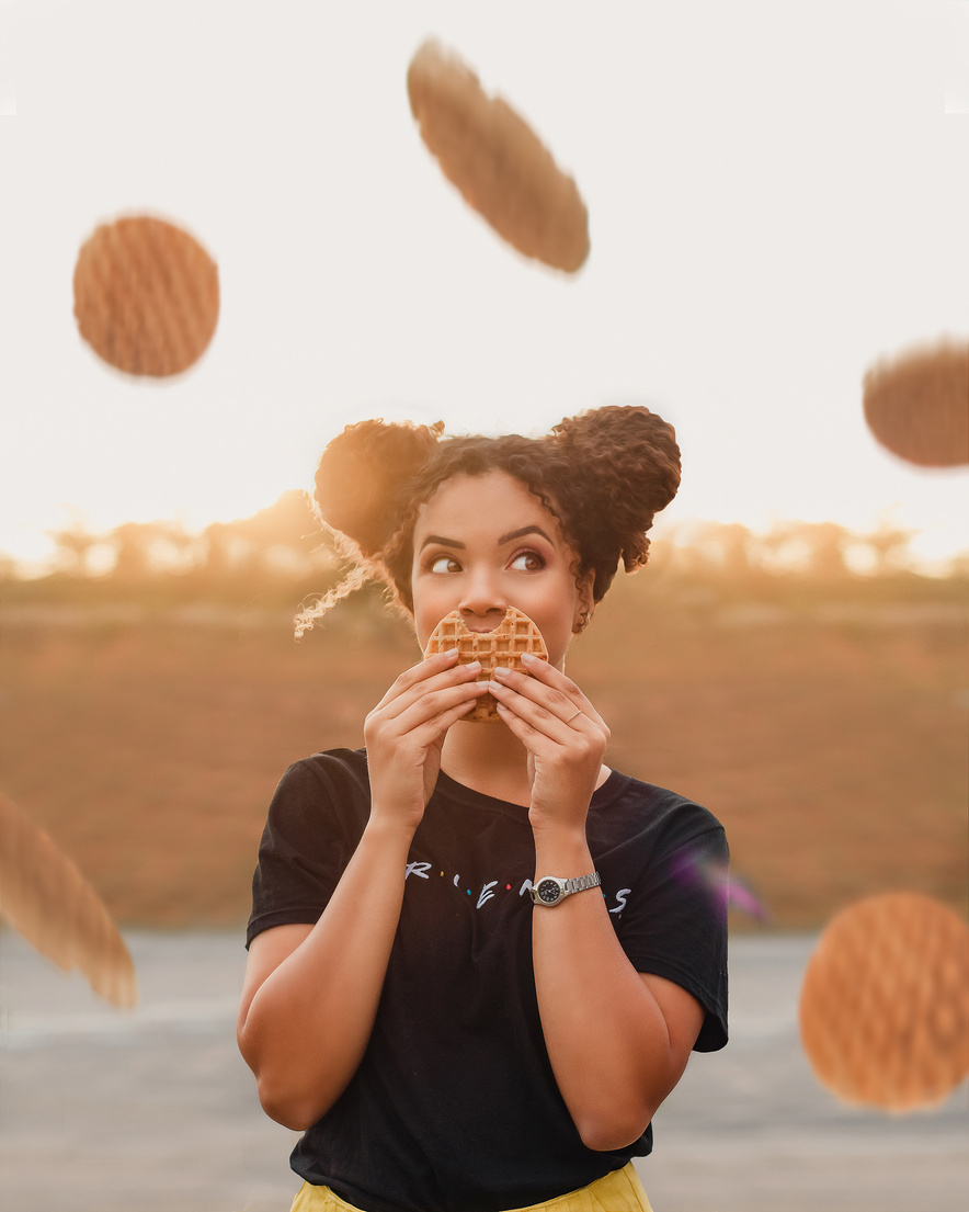 Charming woman eating delicious waffle